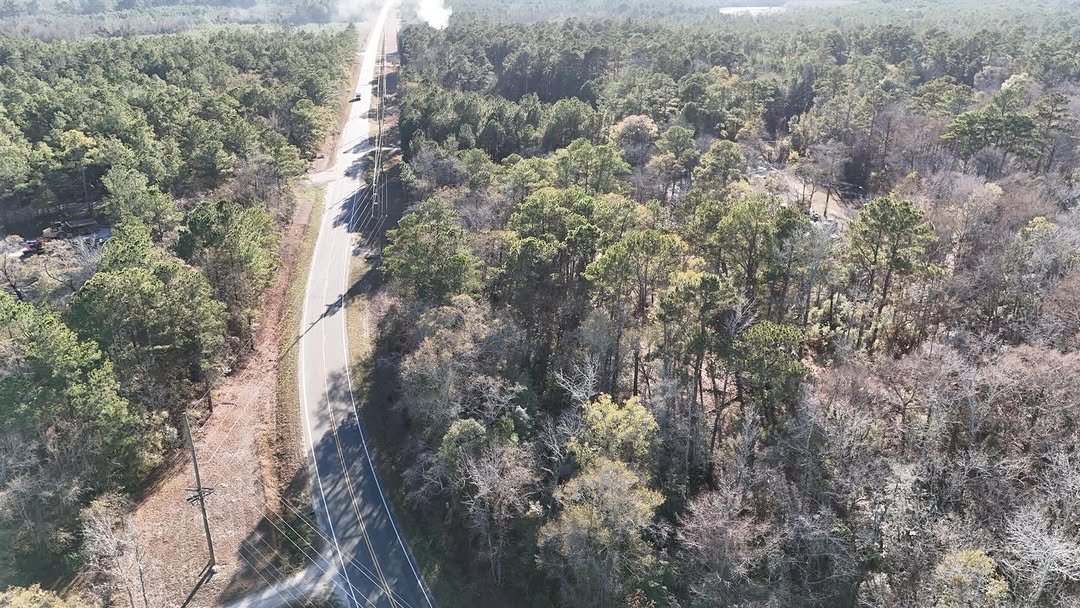 Aerial view of wooded land with road access